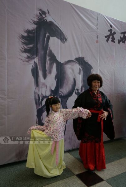 一名小女孩和老人穿传统汉服在照相。广西新闻网记者 邓昶摄