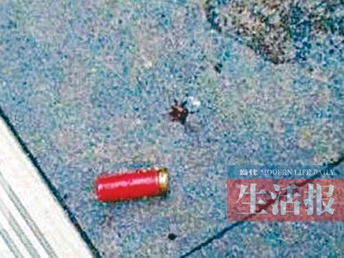 案发现场的餐厅外，地板上留下一个红色弹壳。（网友供图）
