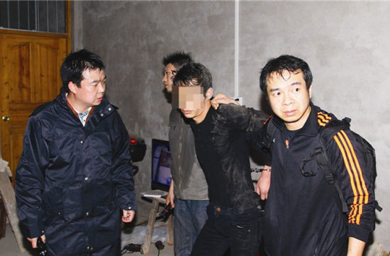 图为4月10日凌晨，民警将一名犯罪嫌疑人（中）抓获。蒋田摄